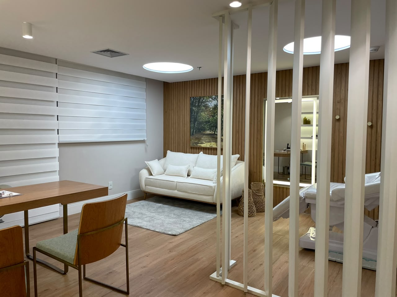 Consultório com mesa de atendimento e sofá branco